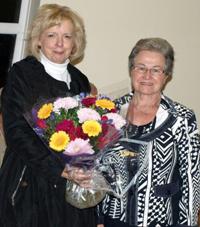 Ann Adams, Enrolling Member, right, presents Diocesan President Moira Thom with flowers.